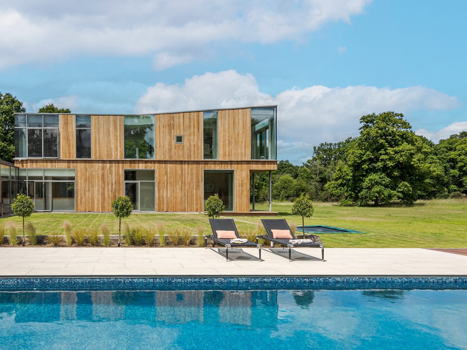 Terrace seating and glass facade at Marama Luxury Home