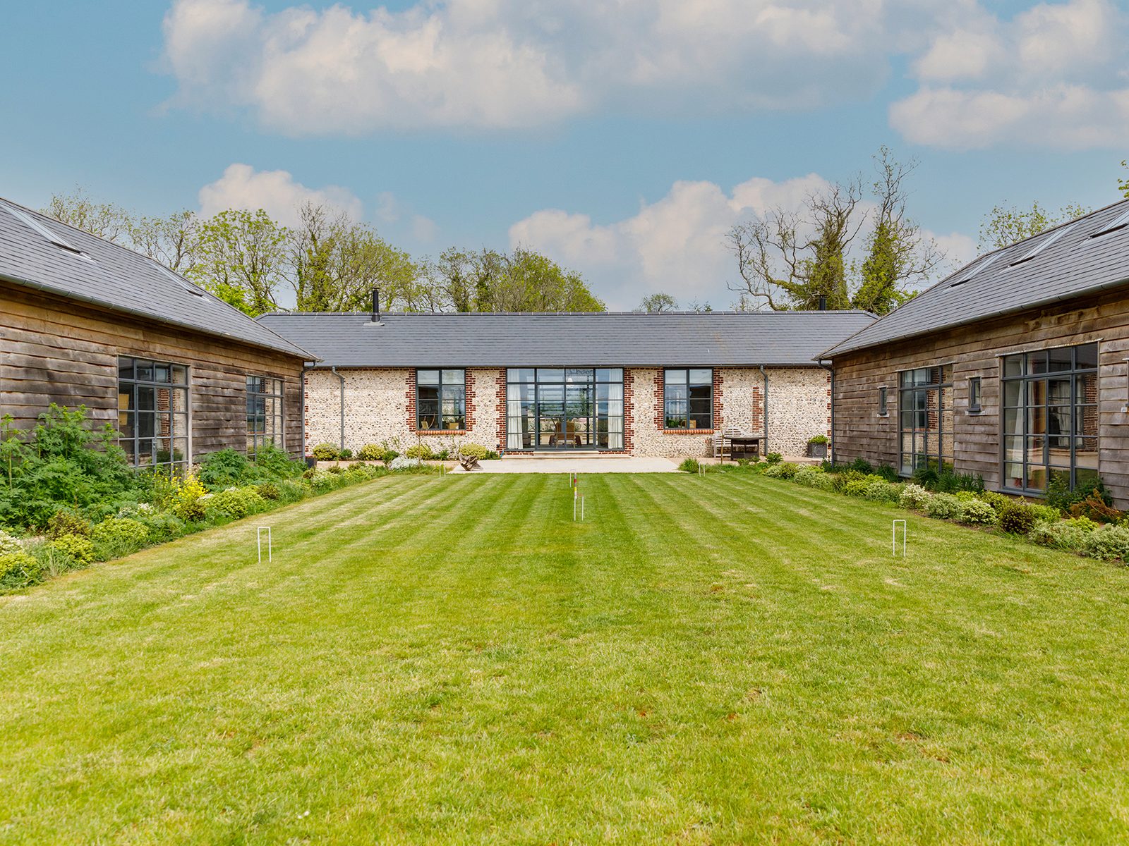 The Farmhouse West Sussex lawn and courtyard view